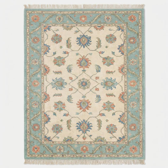 Translation missing: es.Vintage inspired blue and cream Persian style area rug with traditional floral pattern and fringe edge