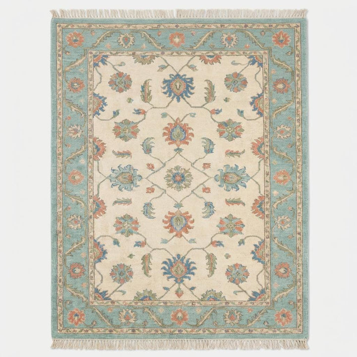 Translation missing: en.Vintage inspired blue and cream Persian style area rug with traditional floral pattern and fringe edge