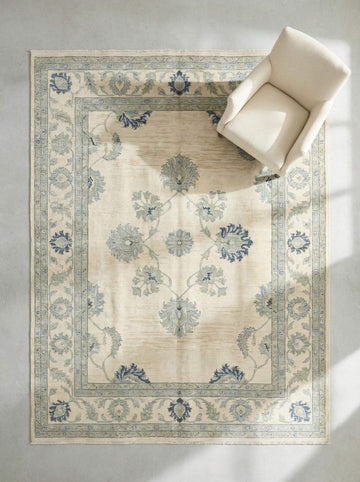 Translation missing: es.Hand knotted wool Oushak rug with muted blue floral design and vintage botanical motifs