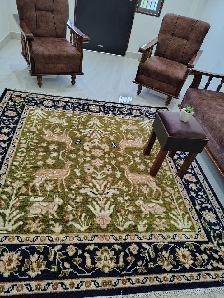 Translation missing: es.Hand knotted wool rug with Persian animal motif and navy floral border on green field