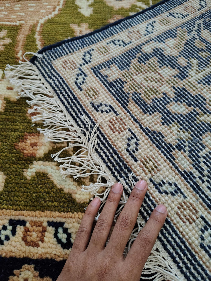 Translation missing: es.Hand knotted wool rug with green Persian animal motif and navy floral border