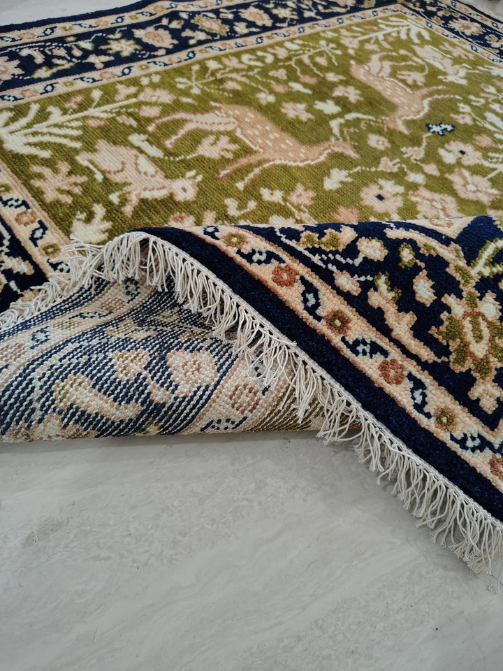 Translation missing: es.Hand knotted wool rug with green Persian animal design and navy floral border