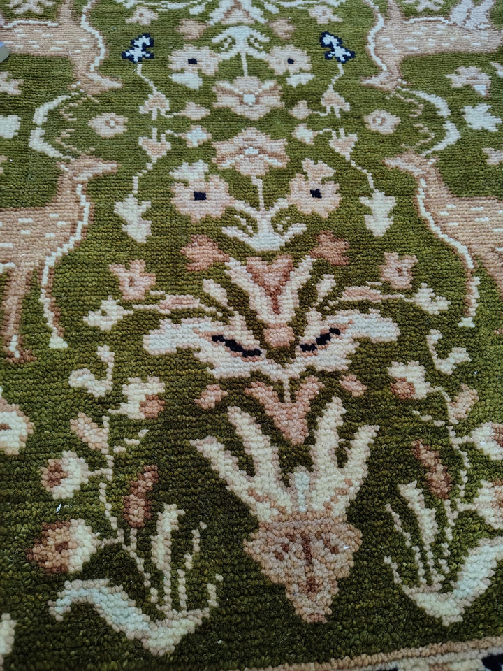 Translation missing: es.Hand knotted wool rug with green Persian animal motifs and navy floral border