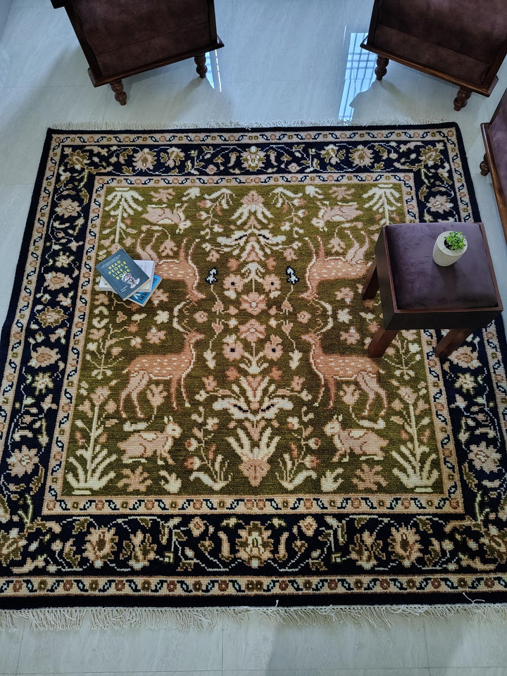 Translation missing: es.Hand knotted wool rug with green Persian animal motif and navy floral border