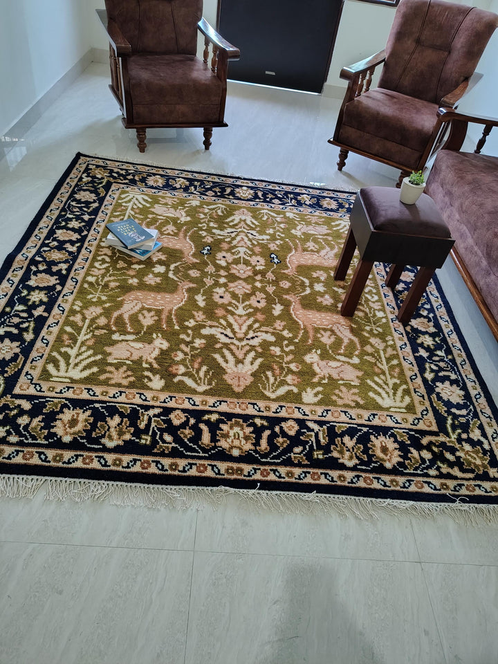 Translation missing: es.Hand knotted wool rug with green Persian animal motif and navy floral border