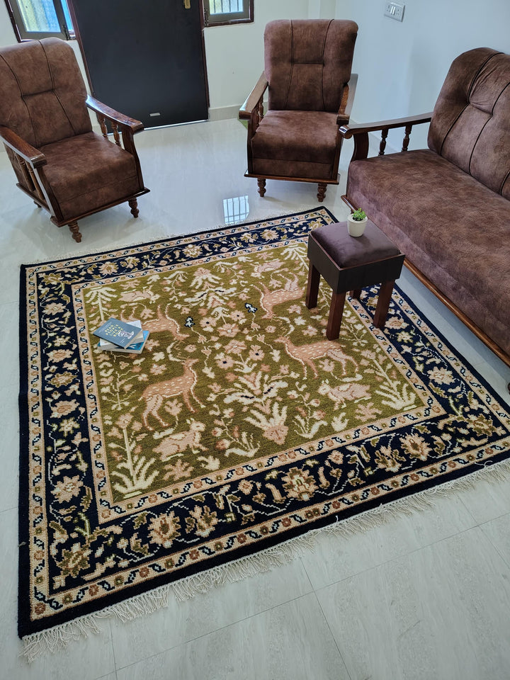 Translation missing: es.Hand knotted wool rug with Persian animal motifs, green field, navy floral border, traditional living room carpet