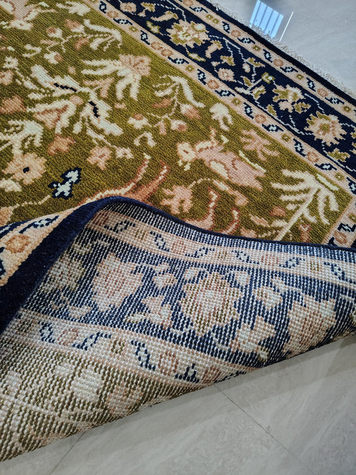 Translation missing: es.Hand knotted wool rug with Persian animal motifs and navy floral border on olive green field
