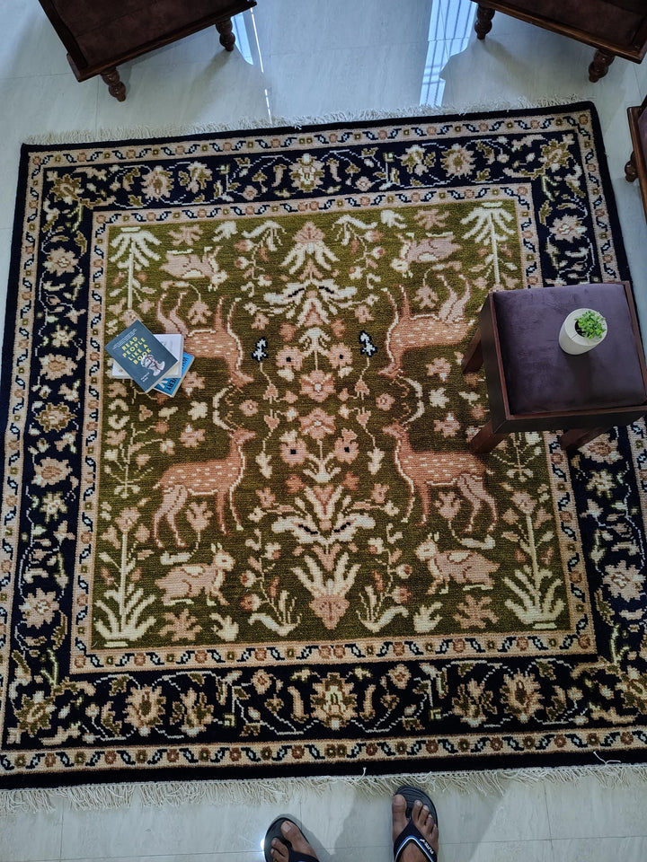Translation missing: es.Hand knotted wool rug with green Persian animal motif and navy floral border