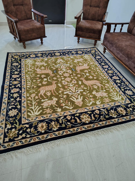 Translation missing: es.Hand knotted wool rug with green Persian animal motifs and navy floral border
