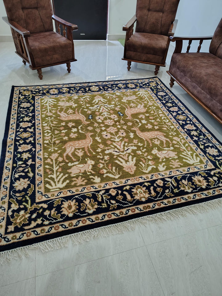 Translation missing: es.Hand knotted wool rug with green Persian animal motifs and navy floral border