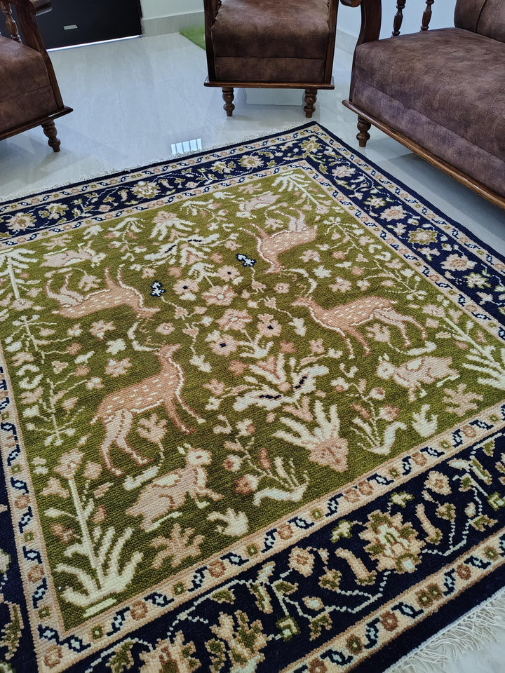 Translation missing: es.Hand knotted wool rug with green Persian animal motif and navy floral border