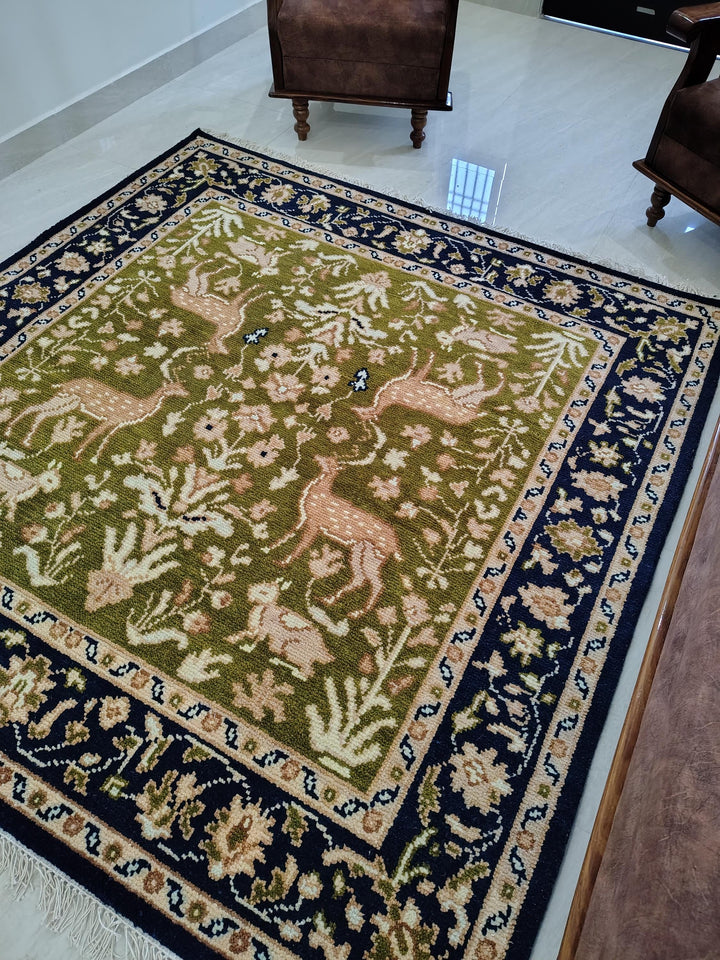 Translation missing: es.Hand knotted wool rug with green Persian animal motif and navy floral border
