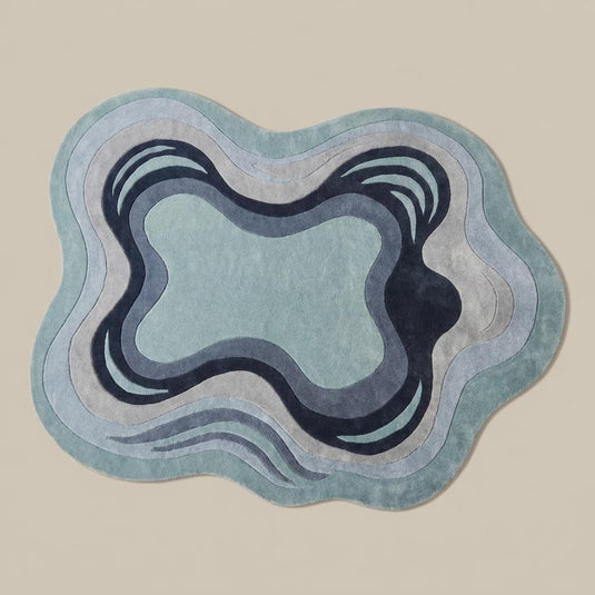 Translation missing: es.Contemporary irregular area rug in soft blue and ivory colors placed beside a boucle accent chair in minimalist interior __etsy:8065990563
