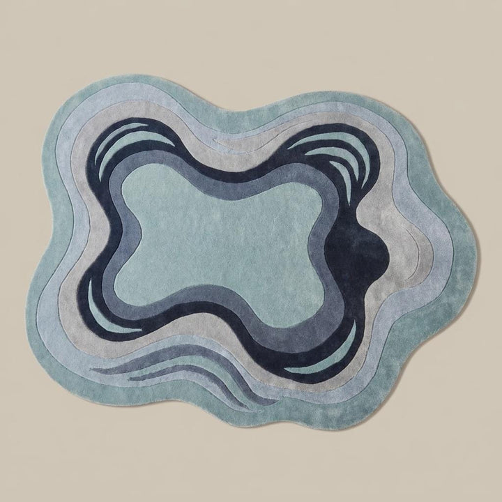 Translation missing: es.Contemporary irregular area rug in soft blue and ivory colors placed beside a boucle accent chair in minimalist interior __etsy:8065990563