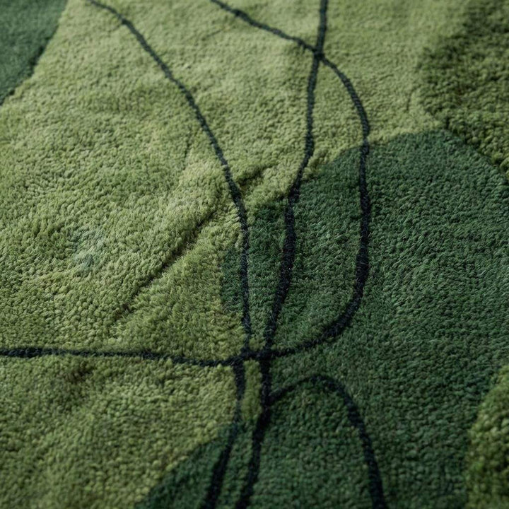 Translation missing: en.Close up of hand tufted wool rug showing thick pile and carved abstract line detailing