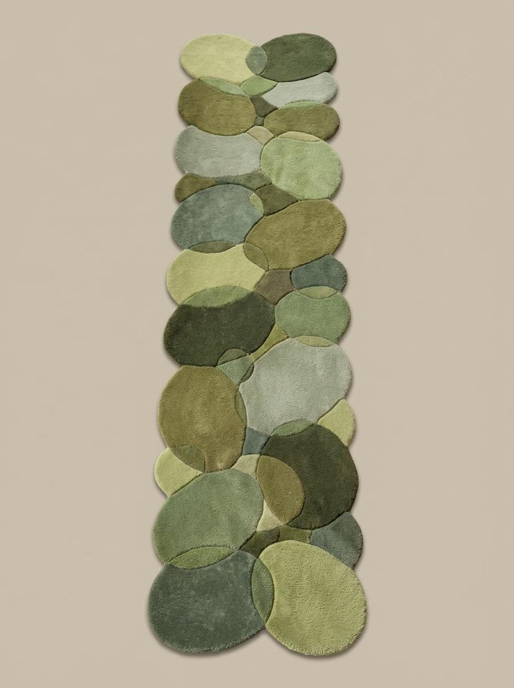 Translation missing: es.Modern organic runner rug with layered moss and sage green pebble shapes on wood floor
