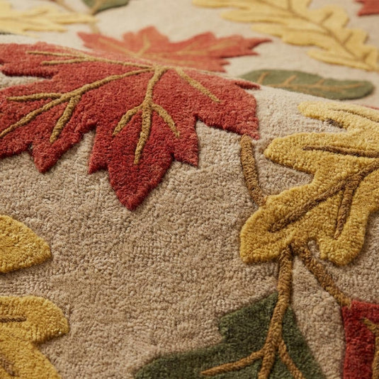 Translation missing: en.Close up of hand tufted wool pile showing carved high low leaf detailing, dense plush fibers, and sculpted floral edges in rust and olive tones