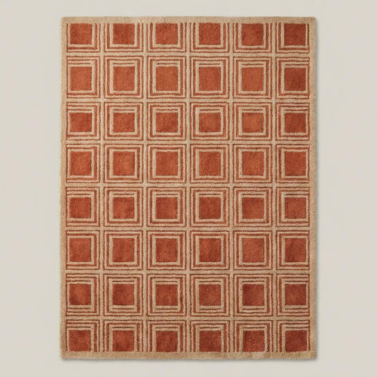 Translation missing: es.Modern rust terracotta wool area rug with geometric square grid design styled beside accent chair and wooden console