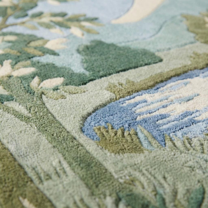 Translation missing: en.Close-up of hand tufted wool rug showing carved high and low pile texture, dense wool fibers, and sculpted landscape detailing