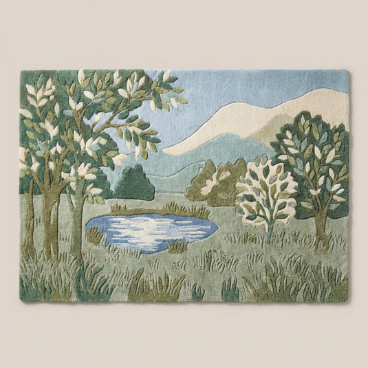 Translation missing: en.Modern green botanical area rug with tree and hill design in sage and olive tones on light wood flooring