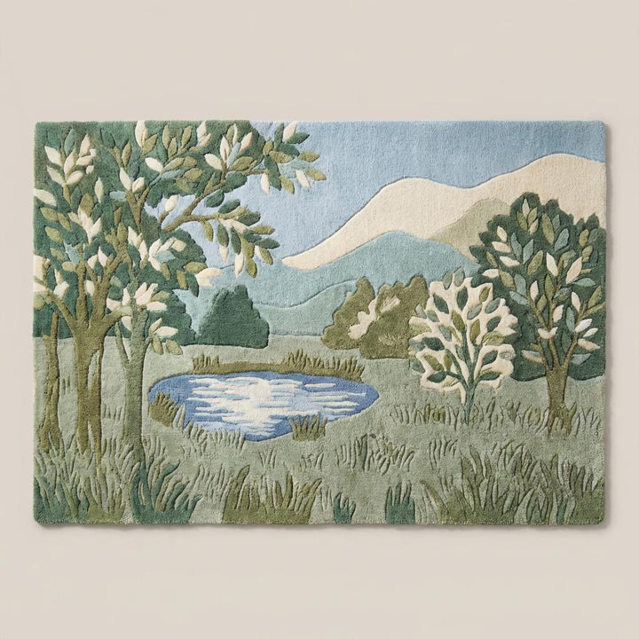 Translation missing: en.Modern green botanical area rug with tree and hill design in sage and olive tones on light wood flooring