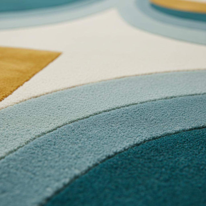 Translation missing: en.Hand-tufted wool rug with mid-century teal and mustard arc design on cream background