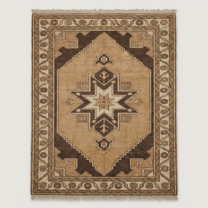 Translation missing: en.Traditional tribal hand knotted area rug featuring geometric motifs and neutral colors on wooden flooring