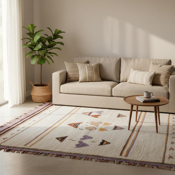 Translation missing: es.Neutral living room styled with blush pink area rug under coffee table and rattan chair