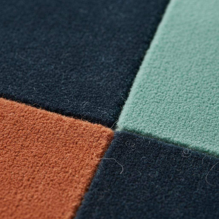 Translation missing: es.Handmade wool rug with modern retro geometric pattern in navy, terracotta, mint, and cream colors