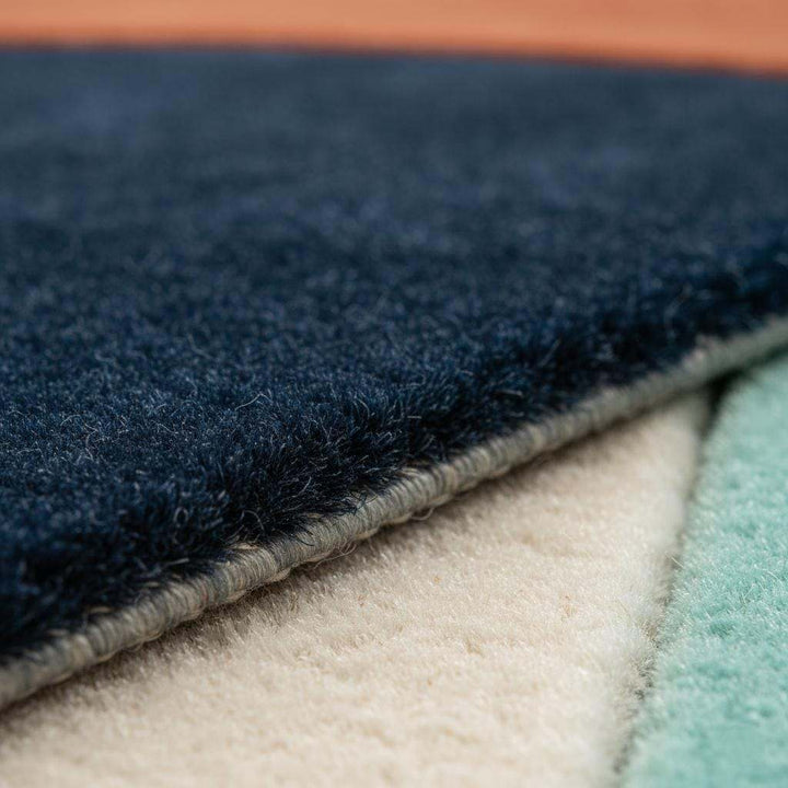 Translation missing: es.Handmade wool rug with modern retro geometric pattern in navy, terracotta, mint, and cream tones
