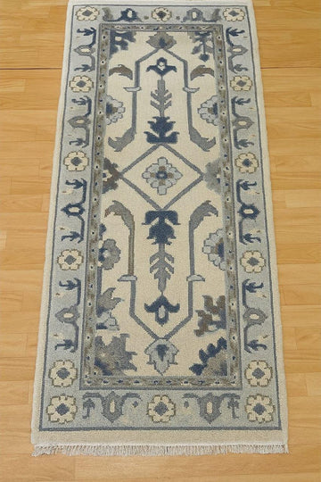Translation missing: fr.Handmade Oushak wool runner rug in ocean blue, green, and ivory floral design, 2.6x7 ft, with orange accents