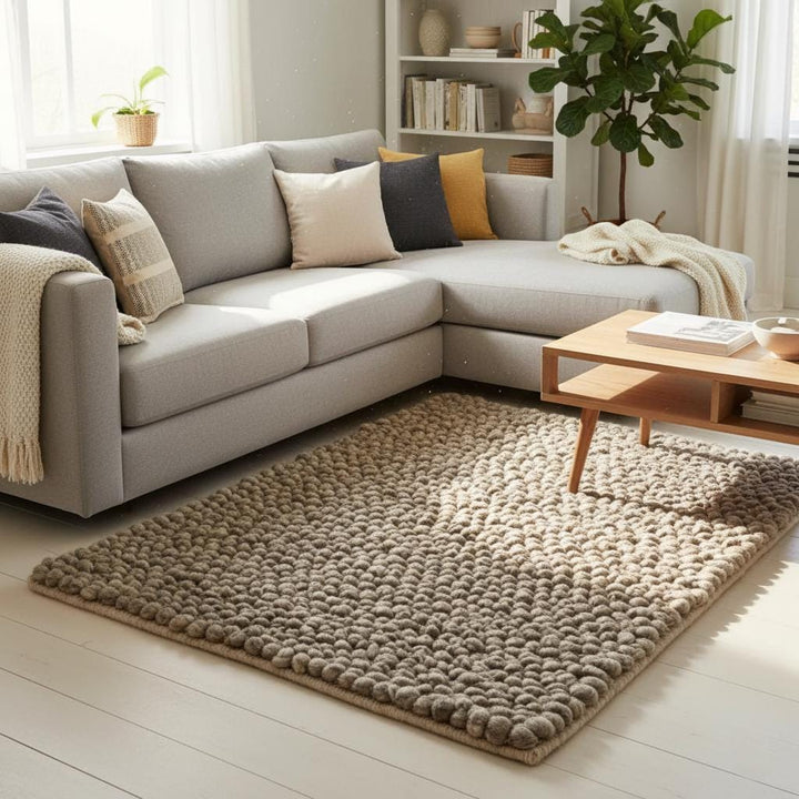 Translation missing: en.Rectangular neutral felt-ball rug in warm stone/taupe, closeup showing tightly felted pom-poms and finished edge — handmade home décor accent