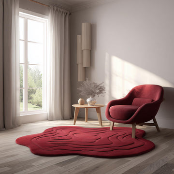 Translation missing: fr.Handmade tufted red rug in modern irregular shape with 3D wave design, styled in a cozy living room with wooden floor, neutral walls, and natural light