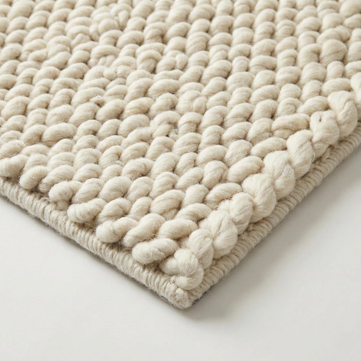 Translation missing: es.Handwoven chunky wool rug with thick braided loops in neutral Scandinavian décor style