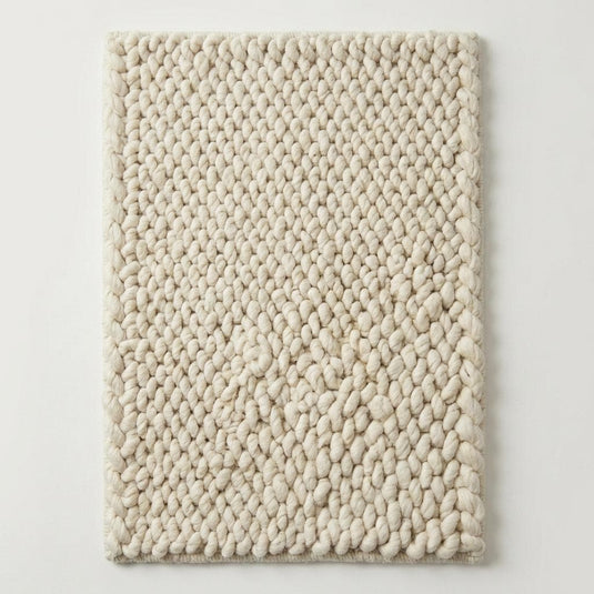 Translation missing: es.Cream chunky wool rug texture featuring braided, handwoven wool fibers for modern boho home décor