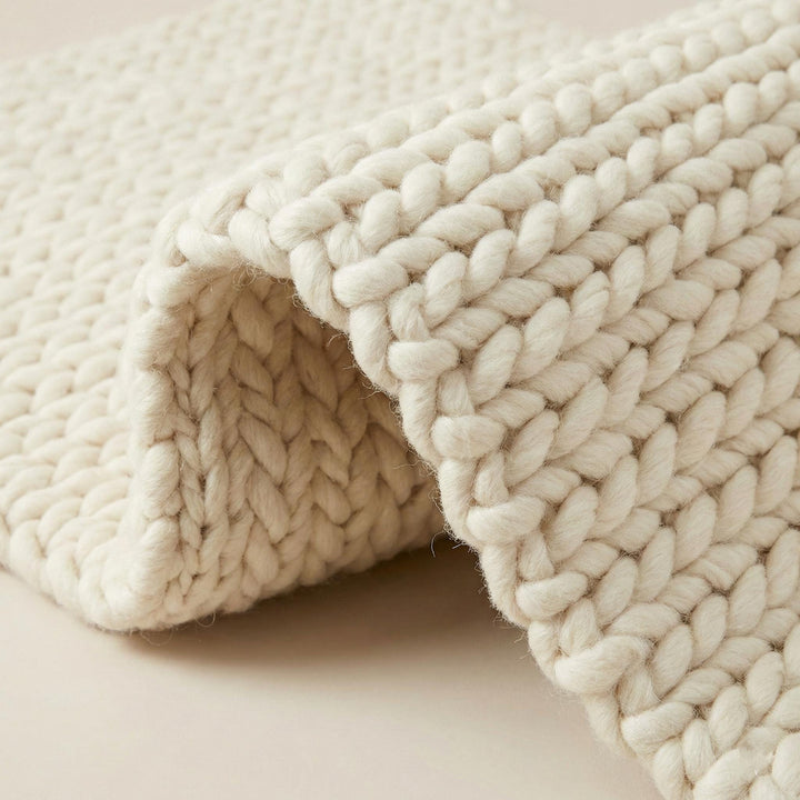 Translation missing: es.Handwoven chunky wool rug in cream with thick knit texture for cozy Scandinavian decor