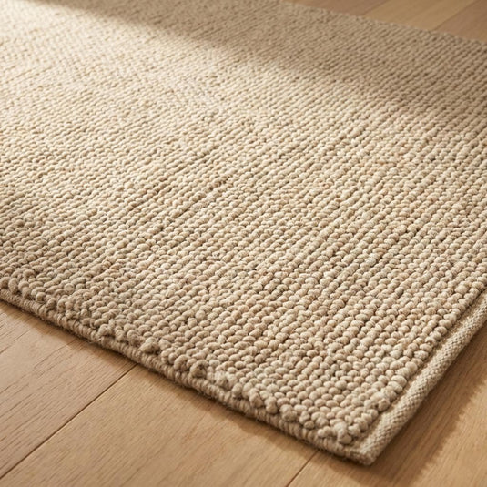 Translation missing: es.Close-up of handwoven wool rug showing chunky loop texture and neutral tone for cozy living room styling