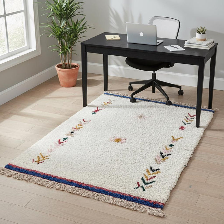 Translation missing: es.Soft cream Berber rug featuring playful tribal symbols and blue-red border, handmade wool carpet for living room or bedroom