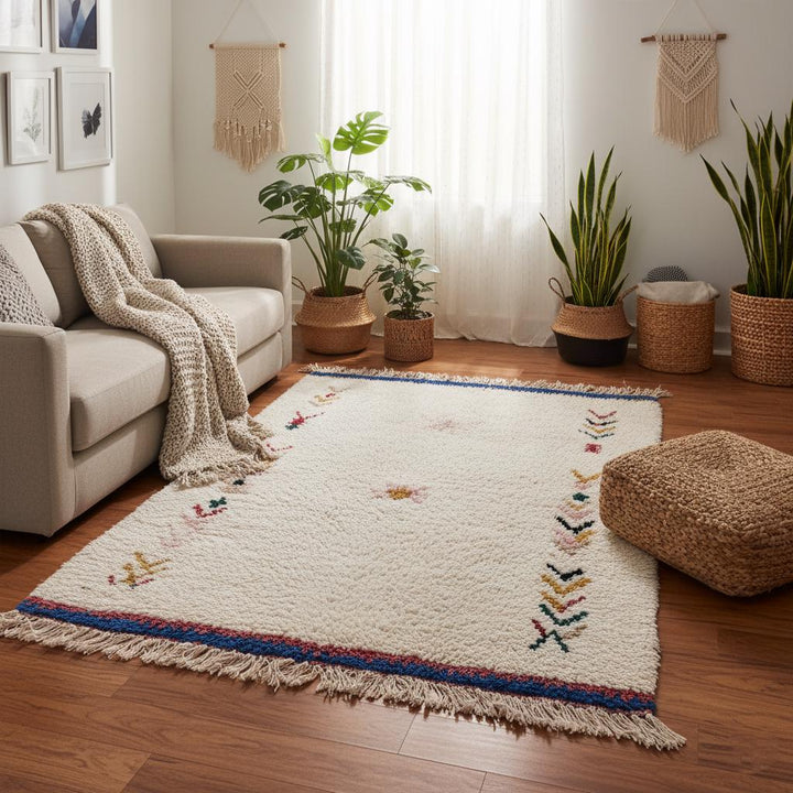 Translation missing: es.Artisan Azilal rug with cream background and geometric tribal details in red, green, yellow, and black, handwoven wool décor