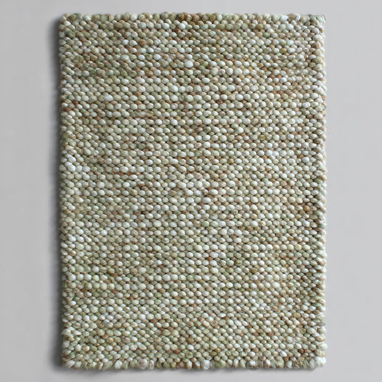 Translation missing: es.Top view of a handmade chunky wool rug with handwoven pebble texture in sage green, cream and tan — felted wool rectangle ideal for nursery or entryway