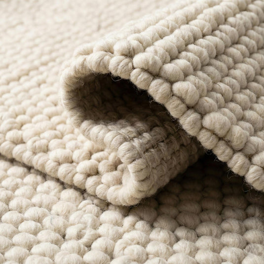 Translation missing: es.Handwoven wool rug with chunky loop pile in neutral ivory for modern minimalist decor