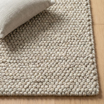 Translation missing: fr.Handwoven chunky wool pebble rug in neutral beige with textured pebble weave for Scandinavian minimalist decor