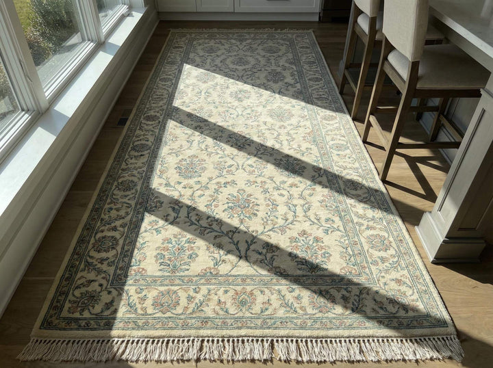 Translation missing: es.Ivory blue floral hand knotted wool area rug with traditional Persian-inspired design and soft ivory base