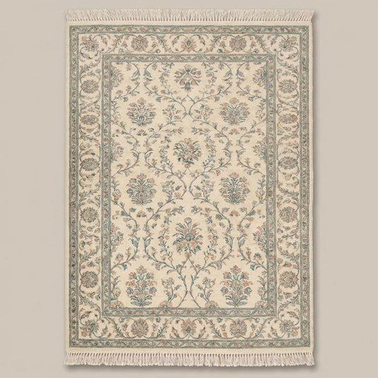 Translation missing: es.Traditional floral hand knotted rug with cotton fringe on wooden flooring