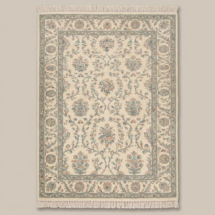 Translation missing: en.Traditional floral hand knotted rug with cotton fringe on wooden flooring