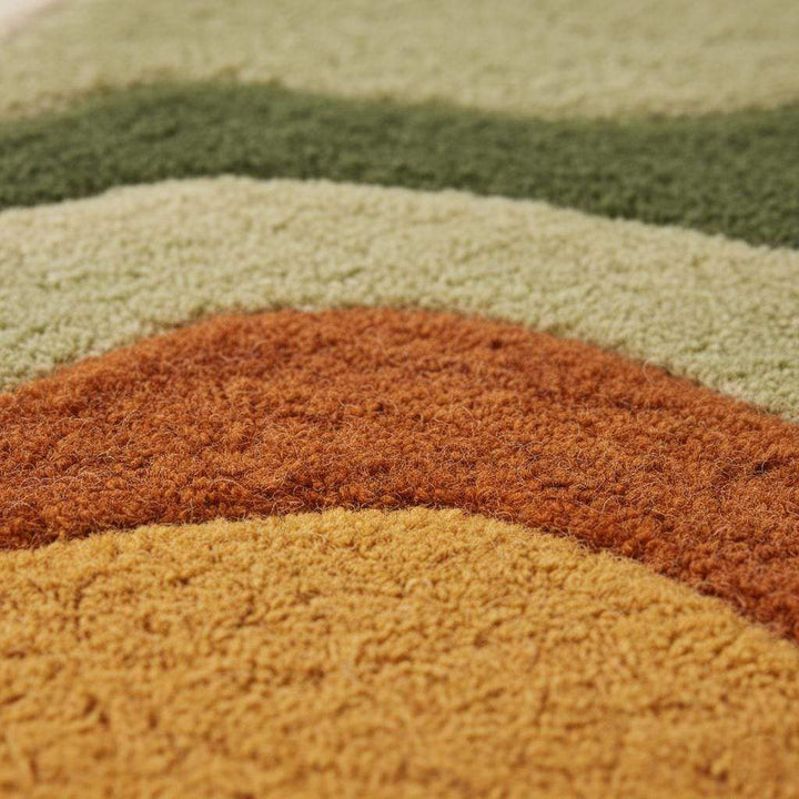 Translation missing: es.Close-up of plush tufted pile and abstract wave pattern on boho shag rug, ideal living room accent