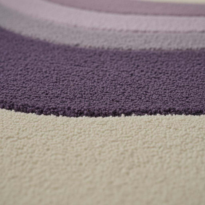 Translation missing: es.Lavender area rug with modern retro curvy stripe pattern, plush tufted surface, and pastel purple tones for living rooms and bedrooms