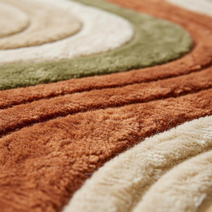 Translation missing: en.Close-up of hand-tufted wool rug showing plush high-pile texture, dense fibers and carved wavy stripe craftsmanship