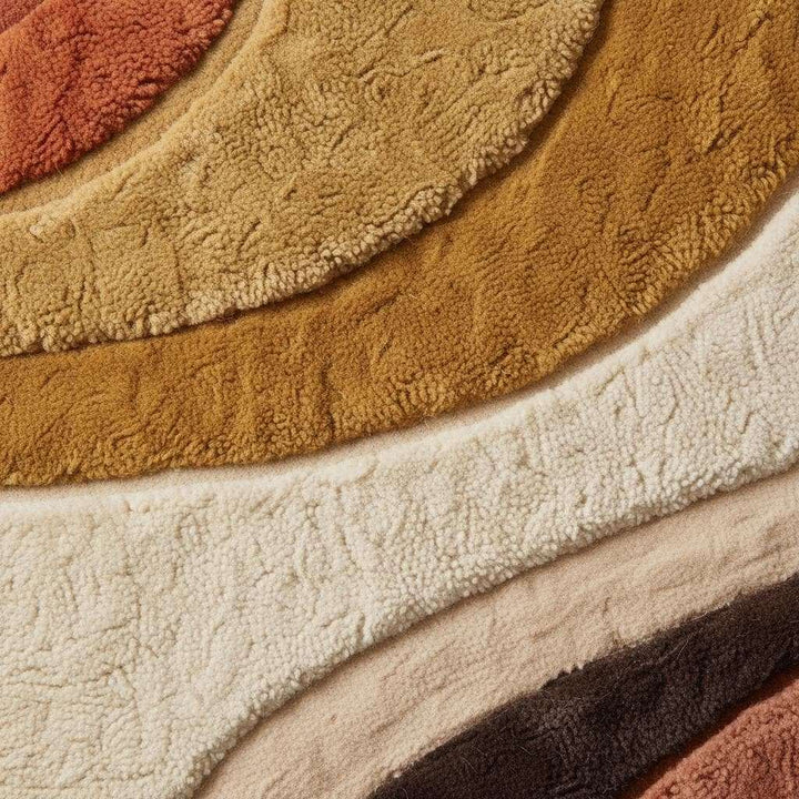 Translation missing: en.Close-up of hand tufted plush rug showing thick pile texture, soft fibers, carved curved lines, and dense wool surface detail