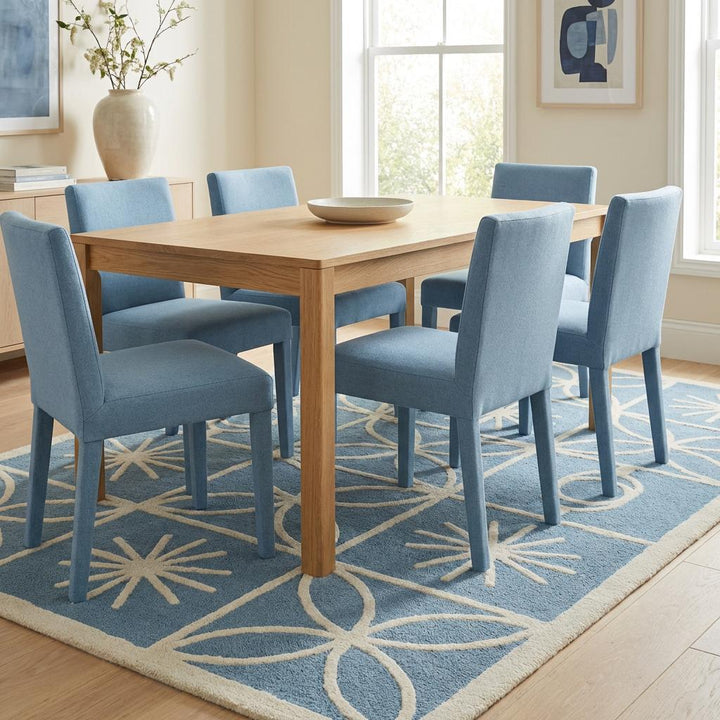 Translation missing: en.Corner detail of blue and cream retro area rug showing reinforced border edge, textured raised pattern, and clean finished stitching